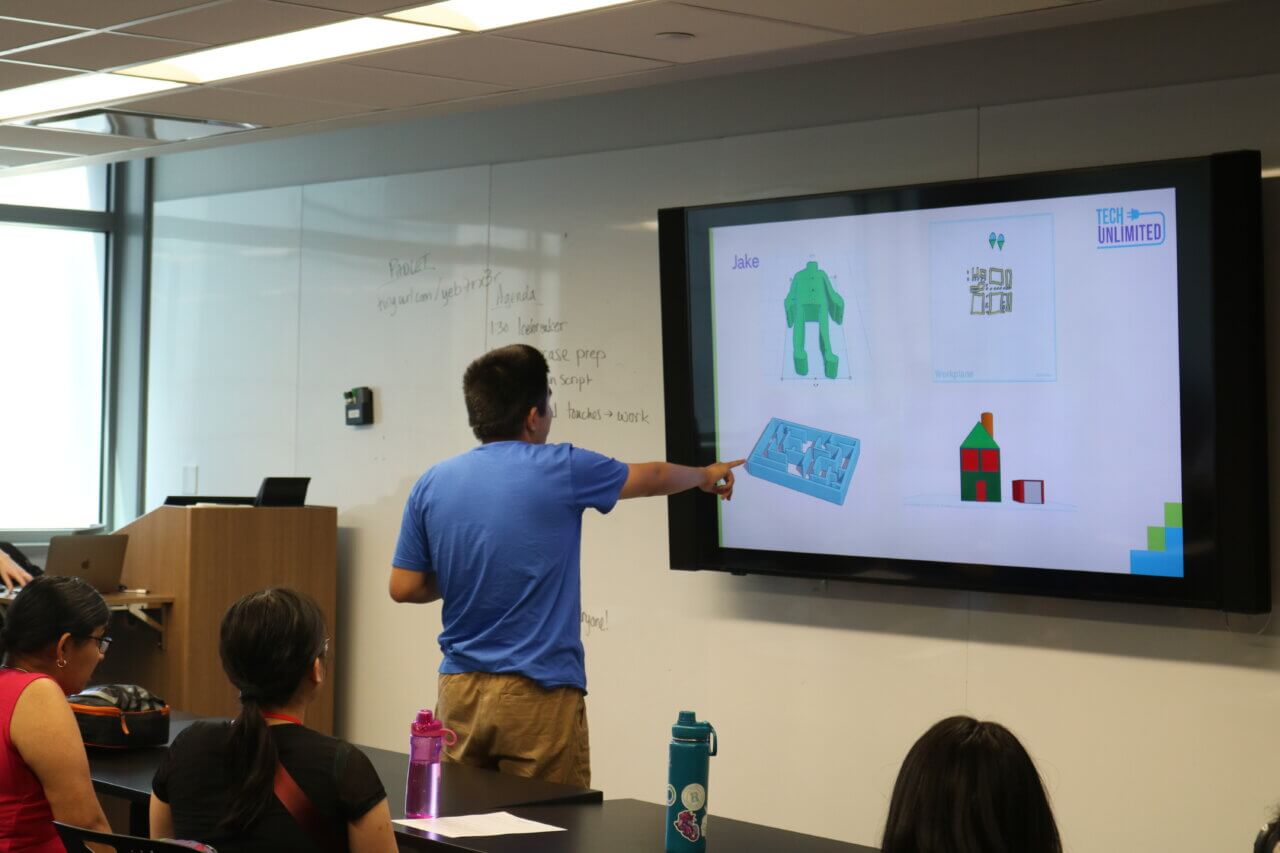 teen pointing at smart whiteboard